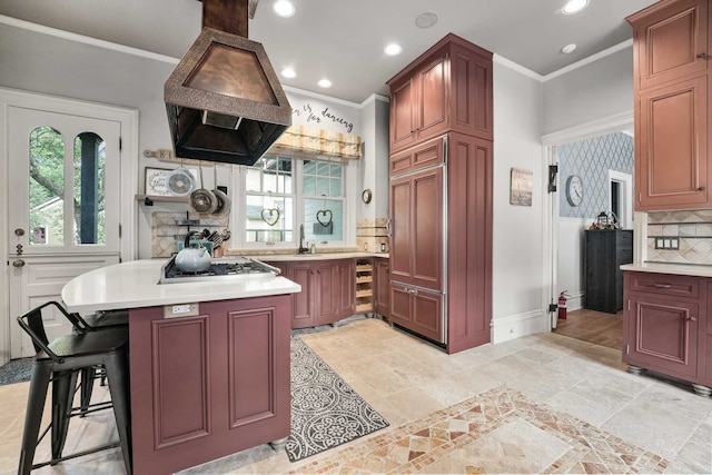 529 Fountain St NE, Grand Rapids, MI 49503 - kitchen featuring gas cooktop, light countertops, healthy amount of natural light, custom range hood, and ornamental molding