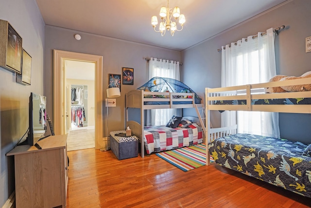 529 Fountain St NE, Grand Rapids, MI 49503 - bedroom featuring wood finished floors, a chandelier, and ornamental molding