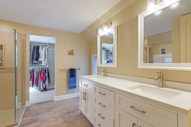 529 Fountain St NE, Grand Rapids, MI 49503 - full bathroom featuring a shower stall, double vanity, and a spacious closet
