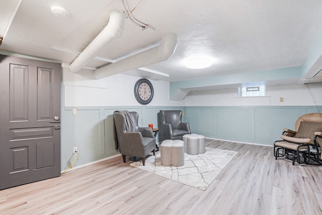 529 Fountain St NE, Grand Rapids, MI 49503 - living area with wood finished floors, a decorative wall, and wainscoting