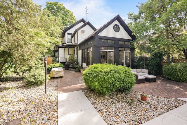 529 Fountain St NE, Grand Rapids, MI 49503 - view of front facade featuring a patio area, a sunroom, and an outdoor hangout area