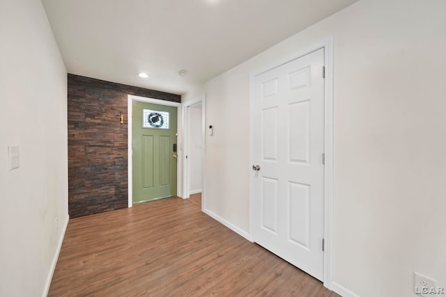 foyer with baseboards, wood finished floors, and recessed lighting