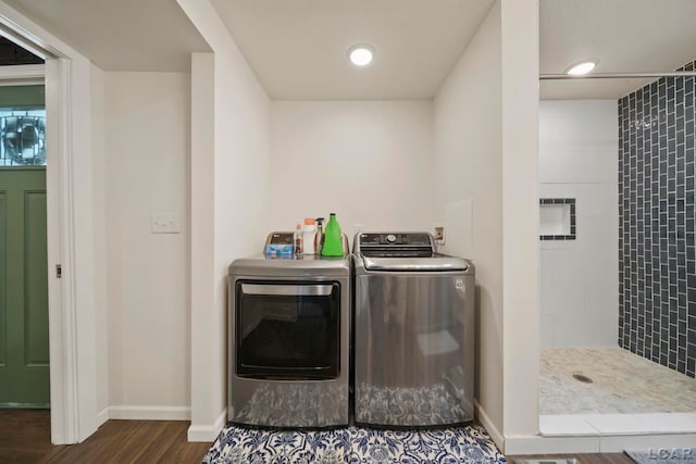 washroom featuring independent washer and dryer, dark wood finished floors, and baseboards