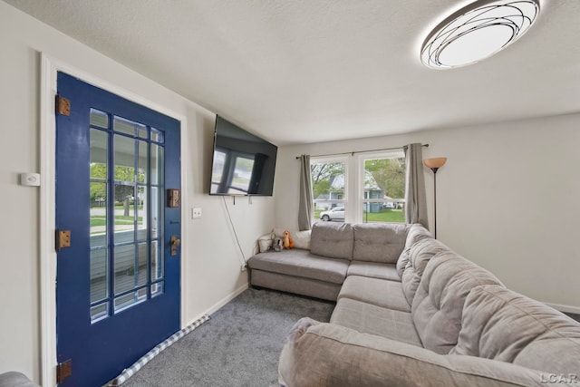 carpeted living area featuring baseboards
