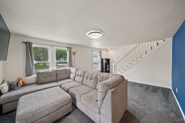 carpeted living area featuring stairway, a textured ceiling, and baseboards