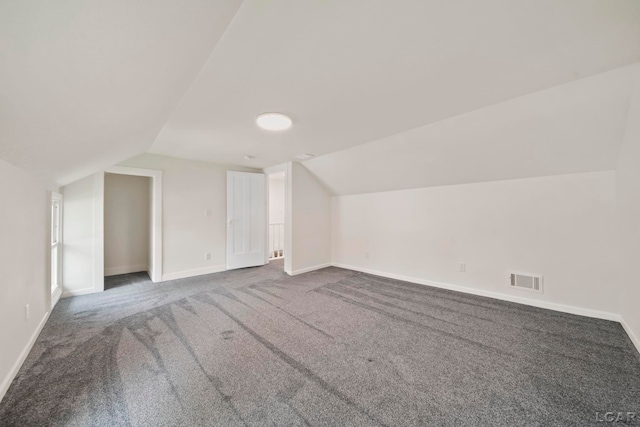 additional living space with lofted ceiling, carpet floors, and baseboards