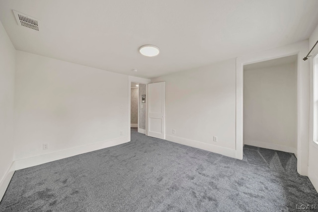 carpeted spare room with baseboards