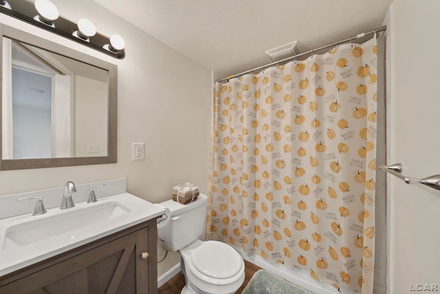 full bathroom with toilet, vanity, and curtained shower
