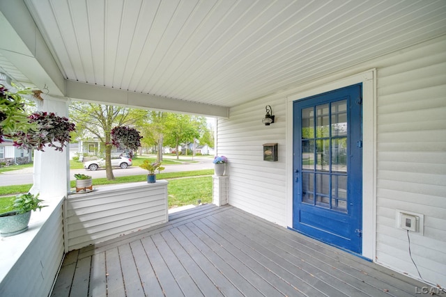 wooden terrace featuring covered porch