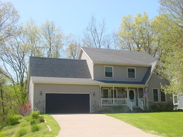 10832 Eagle Cove Dr, South Lyon, MI 48178 - view of front of property with a porch, an attached garage, a front yard, and stone siding