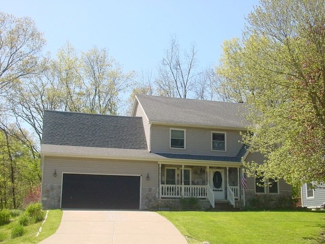 10832 Eagle Cove Dr, South Lyon, MI 48178 - view of front facade with covered porch, an attached garage, concrete driveway, stone siding, and a front yard