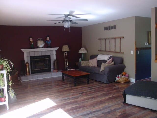 10832 Eagle Cove Dr, South Lyon, MI 48178 - living area featuring wood finished floors, ceiling fan, and a tile fireplace