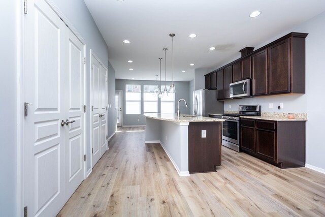 951 Barclay Cir Unit 48, Rochester Hills, MI 48307 - kitchen with stainless steel appliances, baseboards, light wood-style flooring, dark brown cabinetry, and recessed lighting