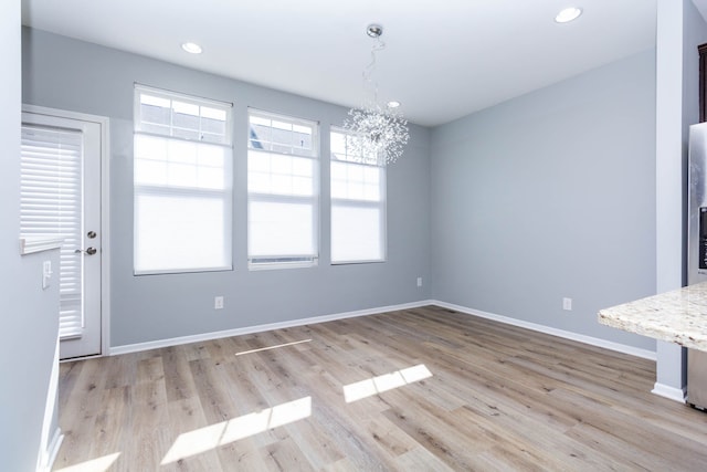 951 Barclay Cir Unit 48, Rochester Hills, MI 48307 - unfurnished dining area with a chandelier, plenty of natural light, light wood-type flooring, baseboards, and recessed lighting