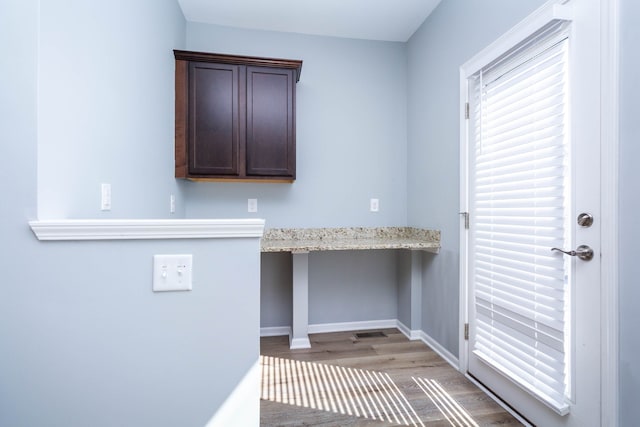 951 Barclay Cir Unit 48, Rochester Hills, MI 48307 - clothes washing area featuring wood finished floors, baseboards, and a desk