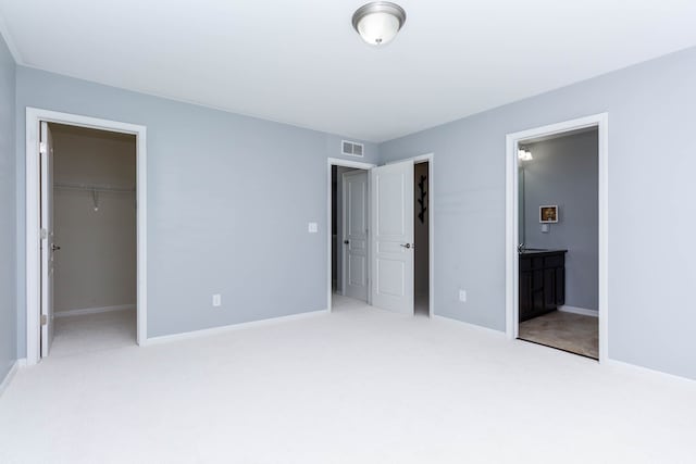 951 Barclay Cir Unit 48, Rochester Hills, MI 48307 - unfurnished bedroom with carpet floors, a walk in closet, and baseboards