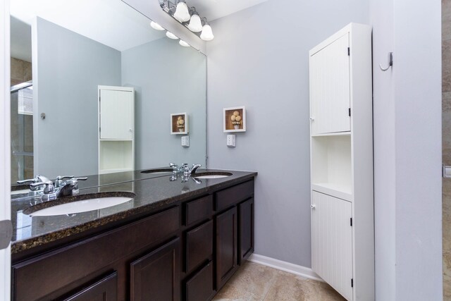 951 Barclay Cir Unit 48, Rochester Hills, MI 48307 - bathroom with double vanity, a tile shower, and baseboards