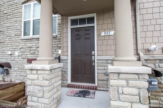 951 Barclay Cir Unit 48, Rochester Hills, MI 48307 - property entrance with stone siding and covered porch