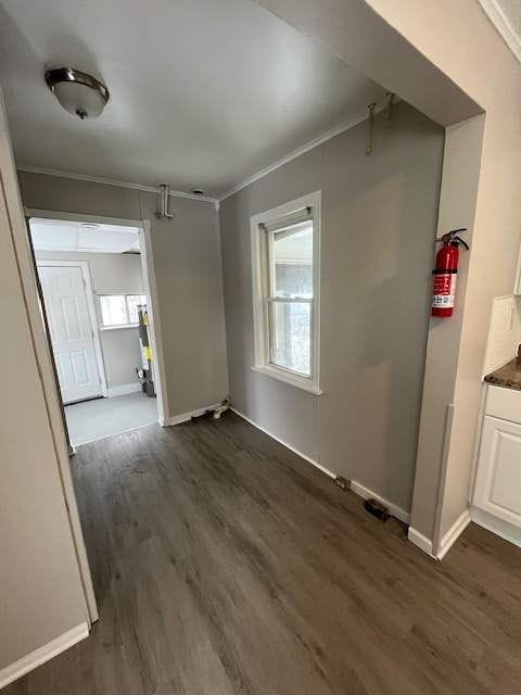 1778 Reo Ave, Lincoln Park, MI 48146 - unfurnished dining area with dark wood finished floors, baseboards, and crown molding