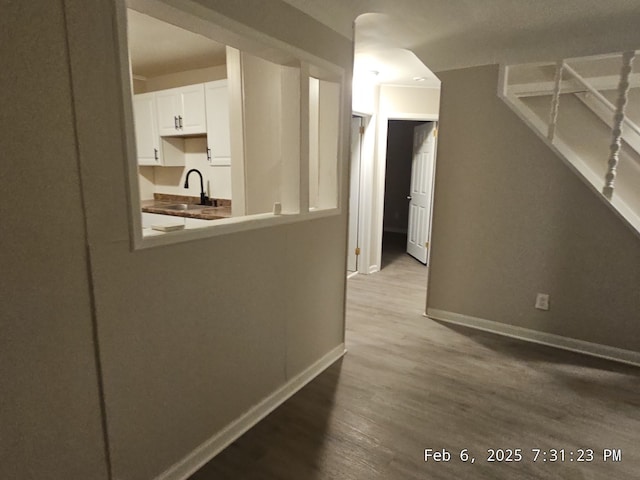 1778 Reo Ave, Lincoln Park, MI 48146 - hall featuring a sink, wood finished floors, and baseboards