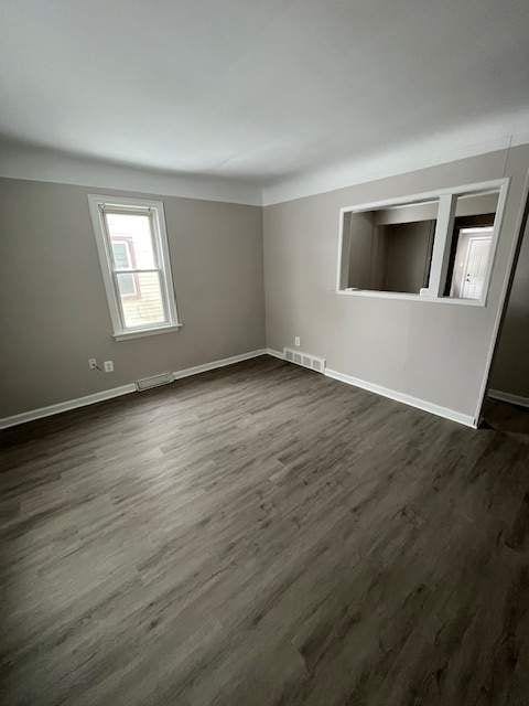 1778 Reo Ave, Lincoln Park, MI 48146 - spare room featuring baseboards and dark wood-type flooring