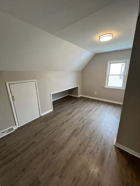1778 Reo Ave, Lincoln Park, MI 48146 - bonus room featuring dark wood-style floors, vaulted ceiling, and baseboards