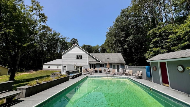 1821 W Hansen Rd, Scottville, MI 49454 - view of swimming pool featuring a patio, outdoor lounge area, an outbuilding, and fence