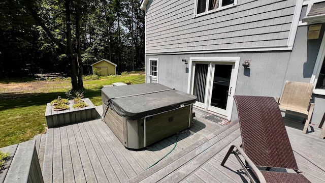 1821 W Hansen Rd, Scottville, MI 49454 - deck featuring a hot tub, a storage unit, an outdoor structure, and a lawn