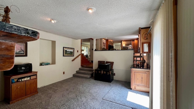 1821 W Hansen Rd, Scottville, MI 49454 - sitting room featuring carpet, stairway, and a textured ceiling