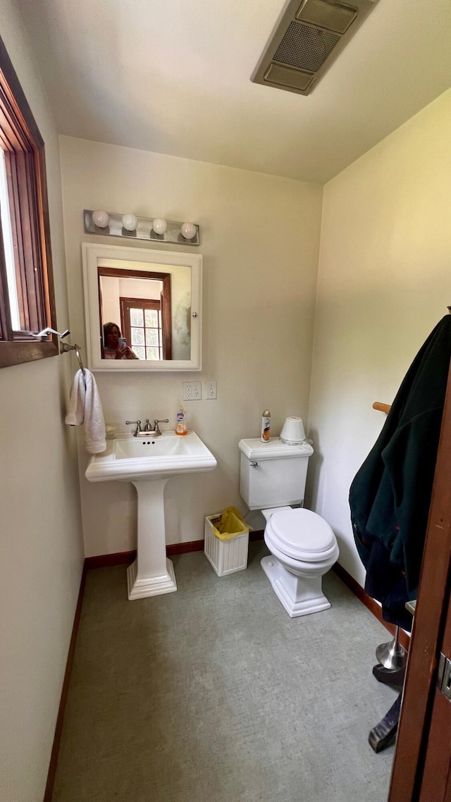 1821 W Hansen Rd, Scottville, MI 49454 - bathroom featuring toilet and baseboards
