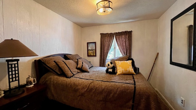 1821 W Hansen Rd, Scottville, MI 49454 - carpeted bedroom featuring a textured ceiling