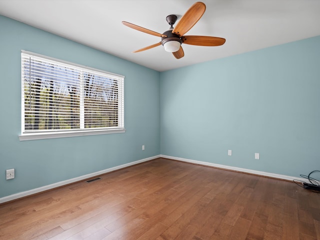 7111 Tucker Rd, Holly, MI 48442 - empty room featuring ceiling fan, wood finished floors, and baseboards