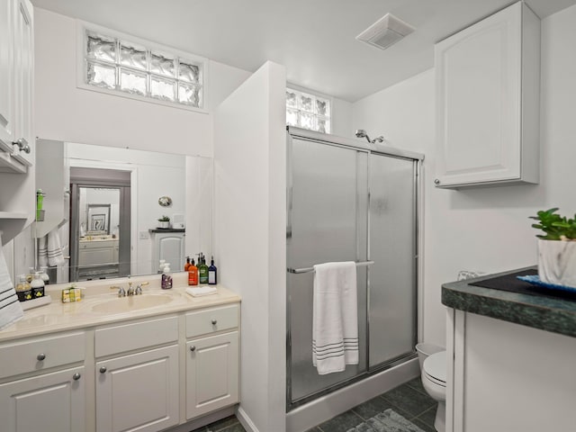 7111 Tucker Rd, Holly, MI 48442 - full bathroom featuring a shower stall, toilet, and vanity