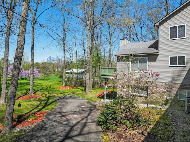 7111 Tucker Rd, Holly, MI 48442 - view of green lawn featuring a wooden deck