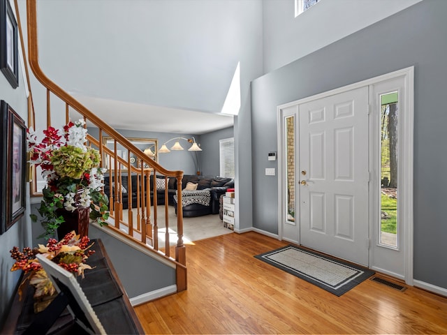 7111 Tucker Rd, Holly, MI 48442 - entryway featuring wood finished floors, healthy amount of natural light, and a towering ceiling