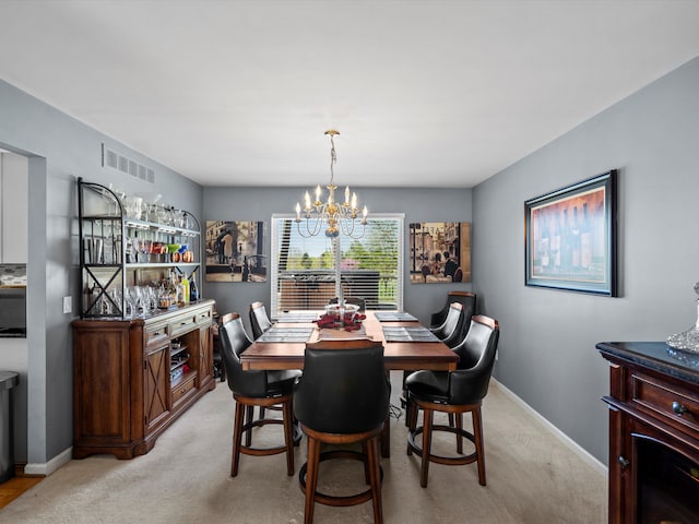 7111 Tucker Rd, Holly, MI 48442 - dining room with a chandelier, light carpet, and baseboards