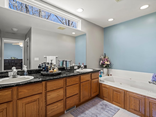 7111 Tucker Rd, Holly, MI 48442 - full bathroom with a whirlpool tub, tile patterned floors, double vanity, ceiling fan, and recessed lighting