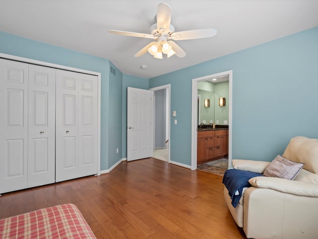 7111 Tucker Rd, Holly, MI 48442 - bedroom with wood finished floors, a closet, baseboards, ceiling fan, and ensuite bathroom