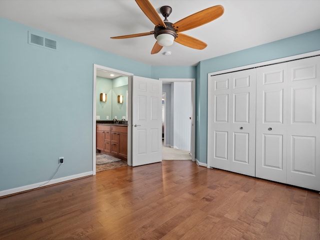 7111 Tucker Rd, Holly, MI 48442 - unfurnished bedroom featuring baseboards, wood finished floors, a closet, and a sink