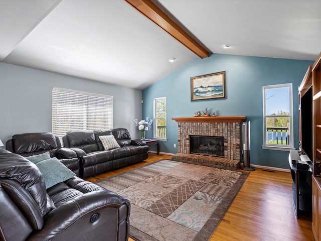 7111 Tucker Rd, Holly, MI 48442 - living room with wood finished floors, a fireplace, and baseboards