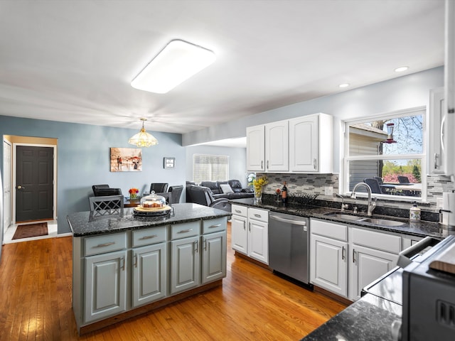 7111 Tucker Rd, Holly, MI 48442 - kitchen featuring stainless steel dishwasher, a sink, a kitchen island, white cabinets, and recessed lighting