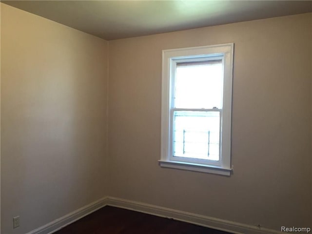19394 Waltham St, Detroit, MI 48205 - unfurnished room featuring plenty of natural light, baseboards, and dark wood-type flooring