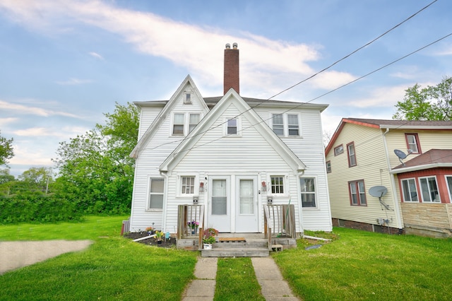 715 N St, Mount Morris, MI 48458 - view of front facade featuring a chimney and a front yard