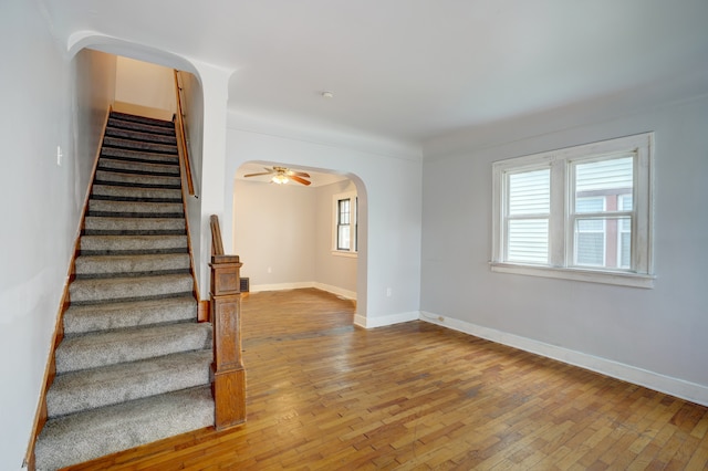 715 N St, Mount Morris, MI 48458 - stairs featuring arched walkways, hardwood / wood-style floors, and plenty of natural light