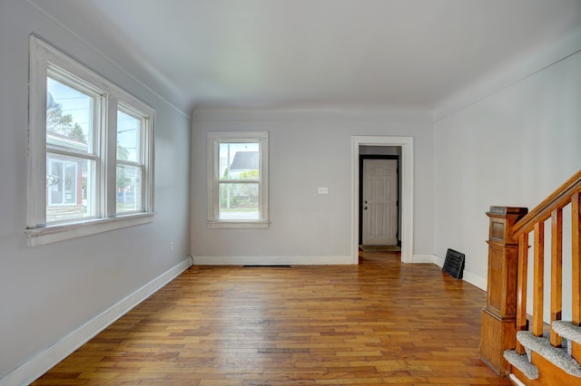 715 N St, Mount Morris, MI 48458 - empty room featuring hardwood / wood-style flooring, stairway, and baseboards