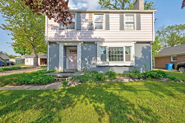 419 S State Rd, Davison, MI 48423 - colonial-style house featuring brick siding, a chimney, and a front yard