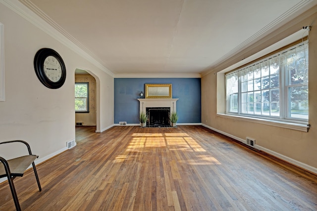 419 S State Rd, Davison, MI 48423 - unfurnished living room with wood finished floors, crown molding, arched walkways, baseboards, and a fireplace with flush hearth