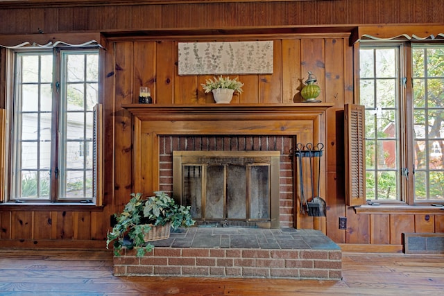 419 S State Rd, Davison, MI 48423 - detailed view of wood walls, a brick fireplace, wood finished floors, and baseboards