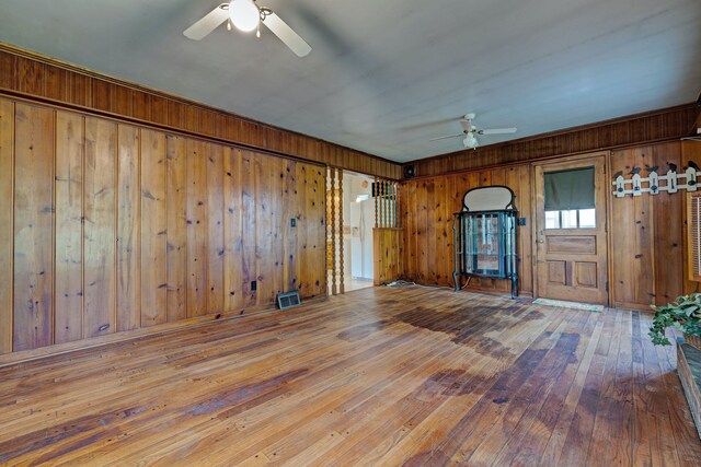 419 S State Rd, Davison, MI 48423 - unfurnished room with a ceiling fan, wooden walls, and hardwood / wood-style floors