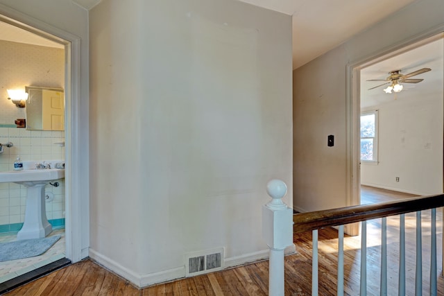 419 S State Rd, Davison, MI 48423 - staircase featuring wood-type flooring, a ceiling fan, and baseboards